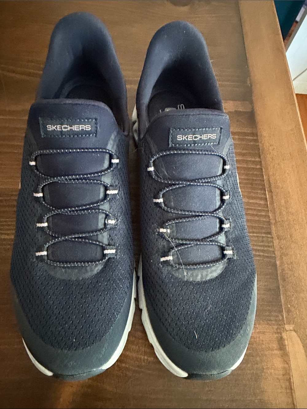 Skechers Women's Slip-On Athletic Sneakers in Navy and White